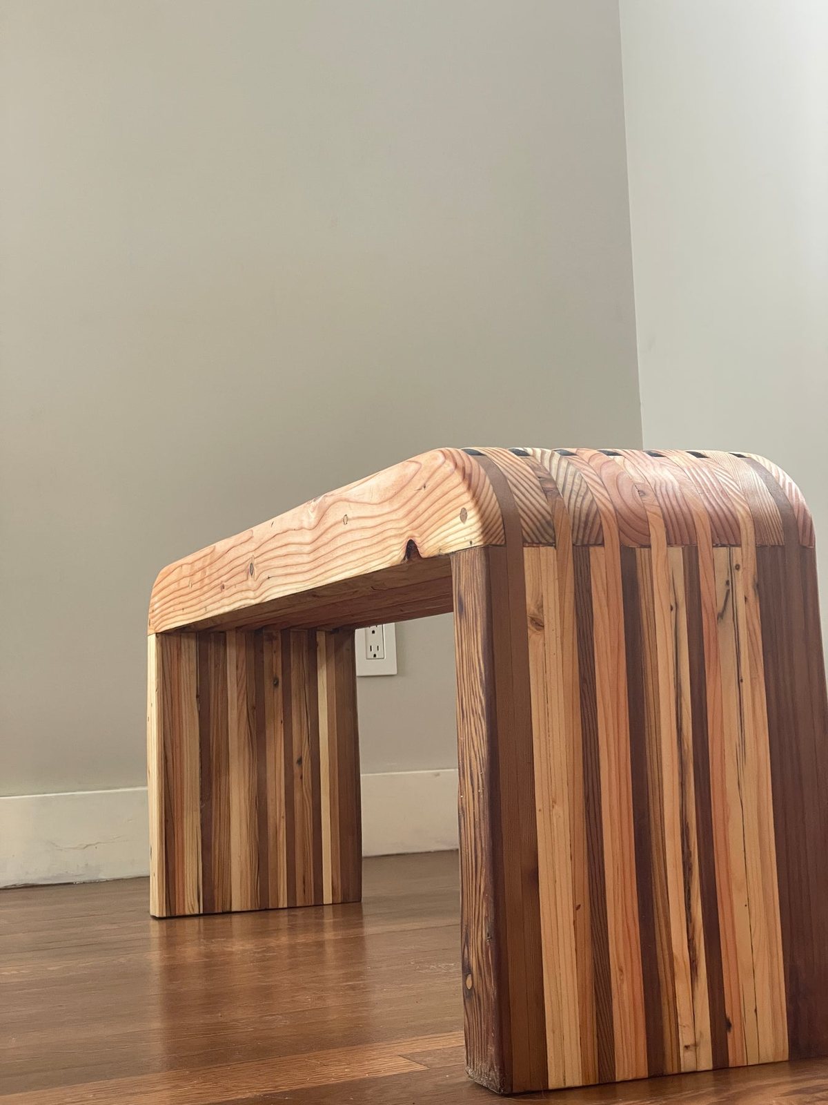 Rounded Palisade Bench, the top wrapping down into the leg in one continuous surface